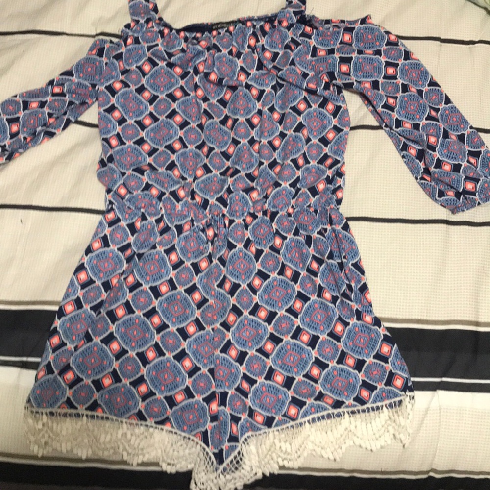 Romper with orange and blue designs.